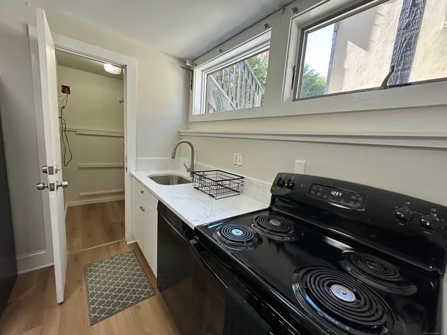 a kitchen with a stove a sink and a refrigerator