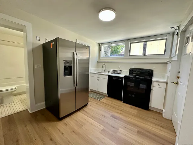 a kitchen with stainless steel appliances granite countertop a refrigerator and a sink