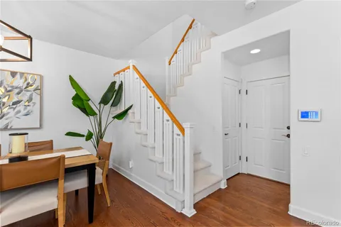 a view of a hallway with furniture and wooden floor