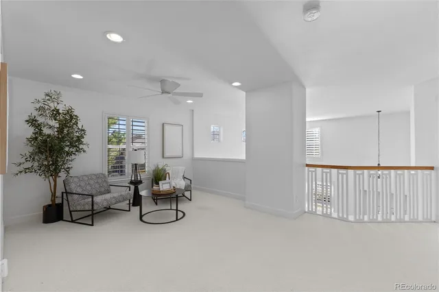 a hallway with furniture and a potted plant