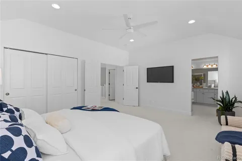 a bedroom with a bed and a potted plant