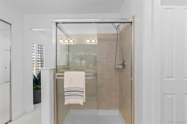 a bathroom with a shower and a mirror