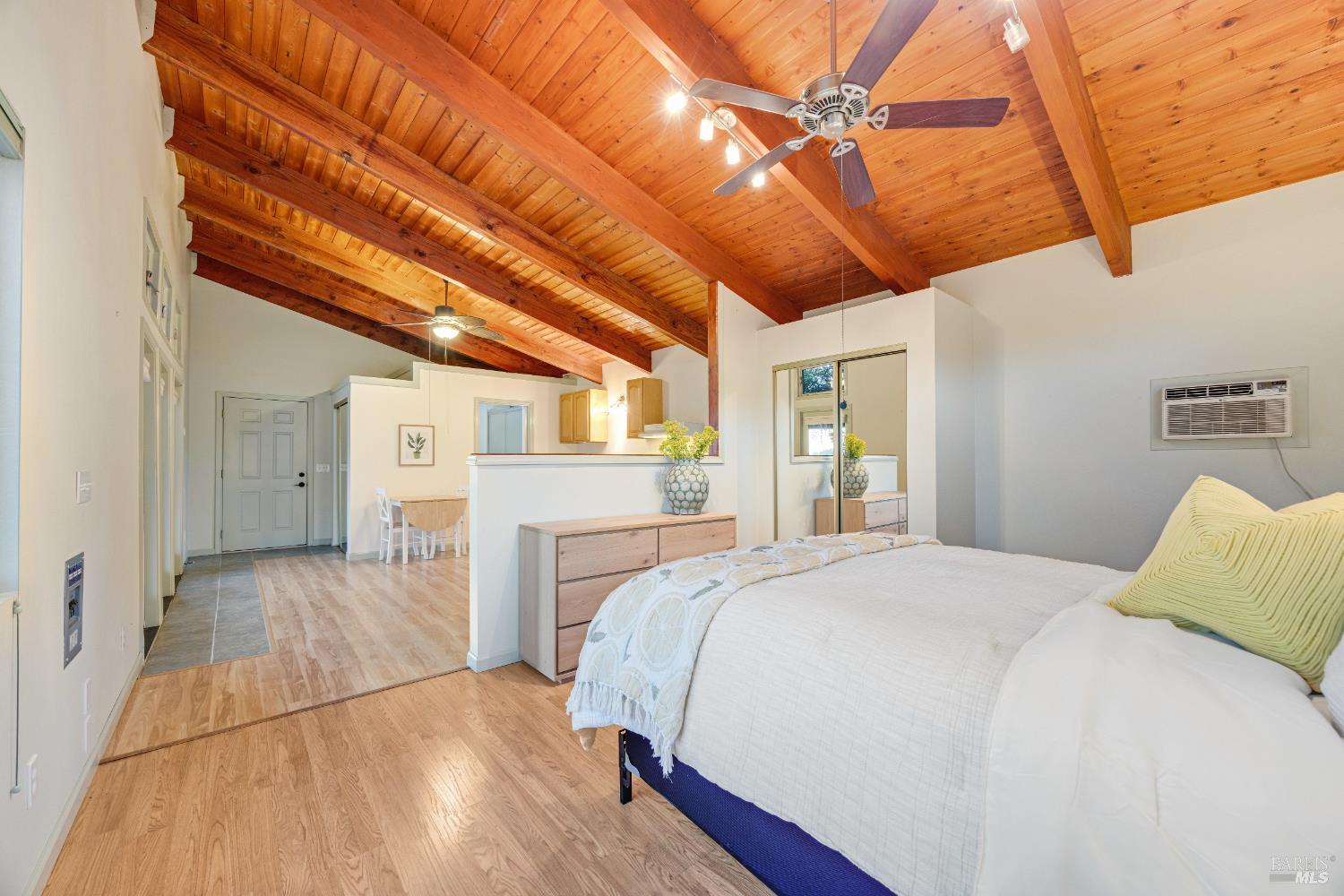6960 Round Oak Road Penngrove, CA 94951 - Photo 36 of 58 a spacious bedroom with a bed and a chandelier