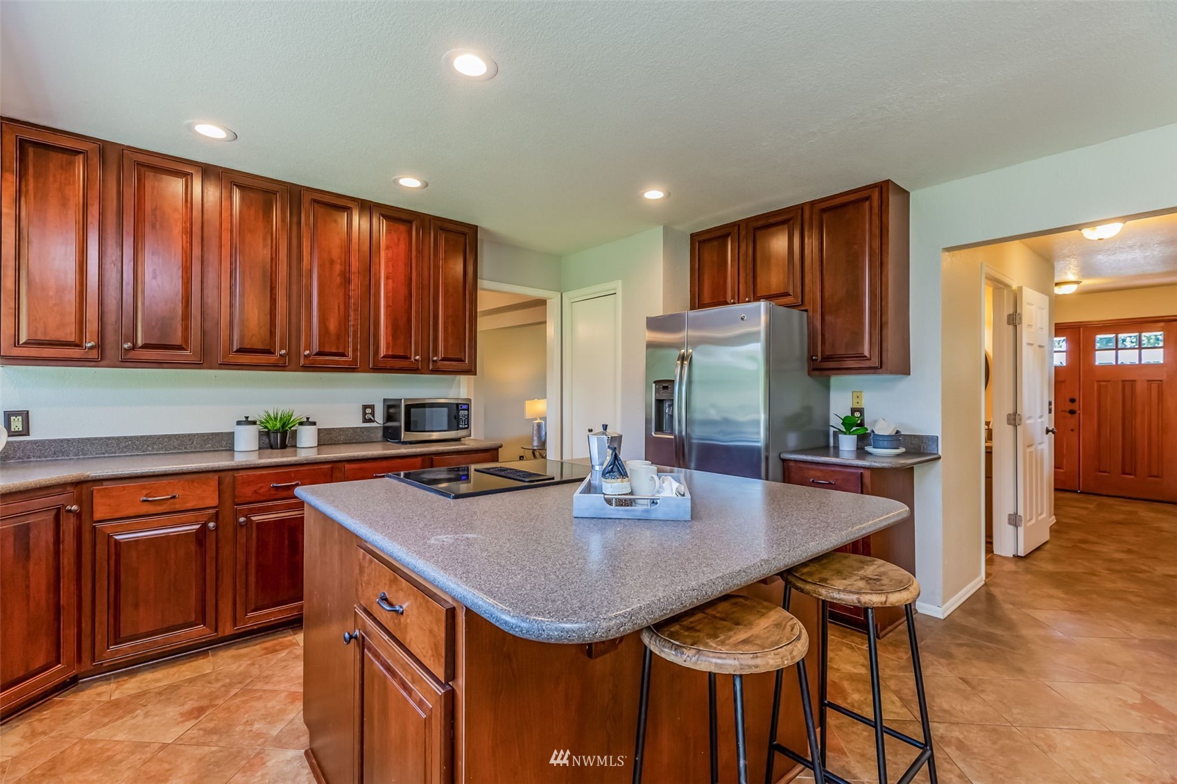 924 Goat Trail Loop Road Mukilteo, WA 98275 - Photo 7 of 40 a kitchen with stainless steel appliances granite countertop a sink counter space and wooden floor