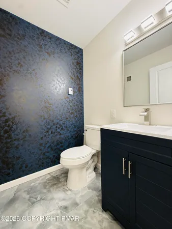 a bathroom with a sink a toilet and mirror