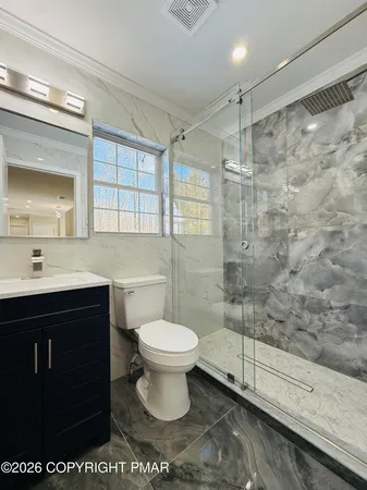 a bathroom with a sink toilet and shower