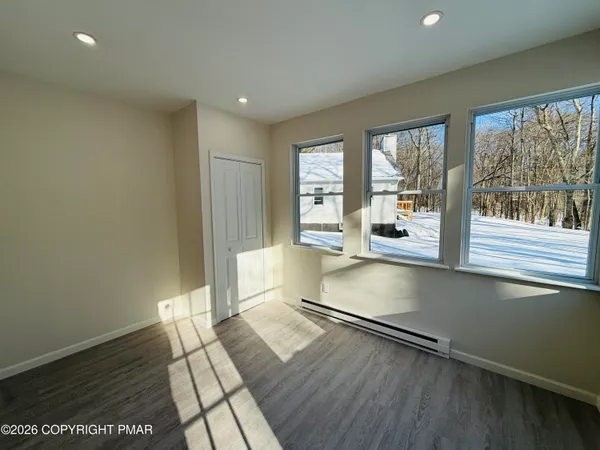 an empty room with wooden floor