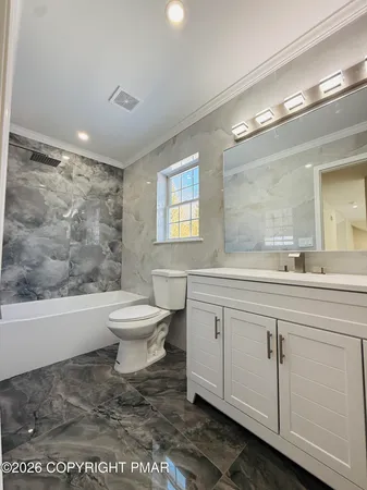 a bathroom with a toilet a sink and mirror
