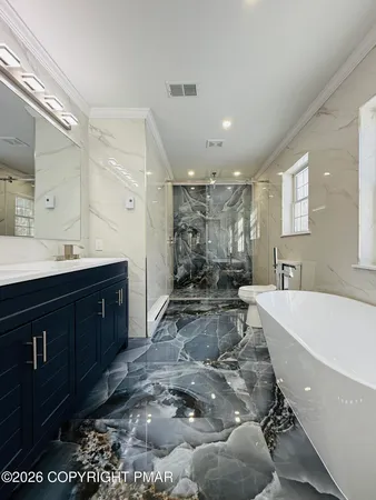a large bathroom with a large tub and sink
