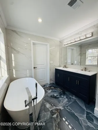 a en suite bathroom with a sink and a mirror