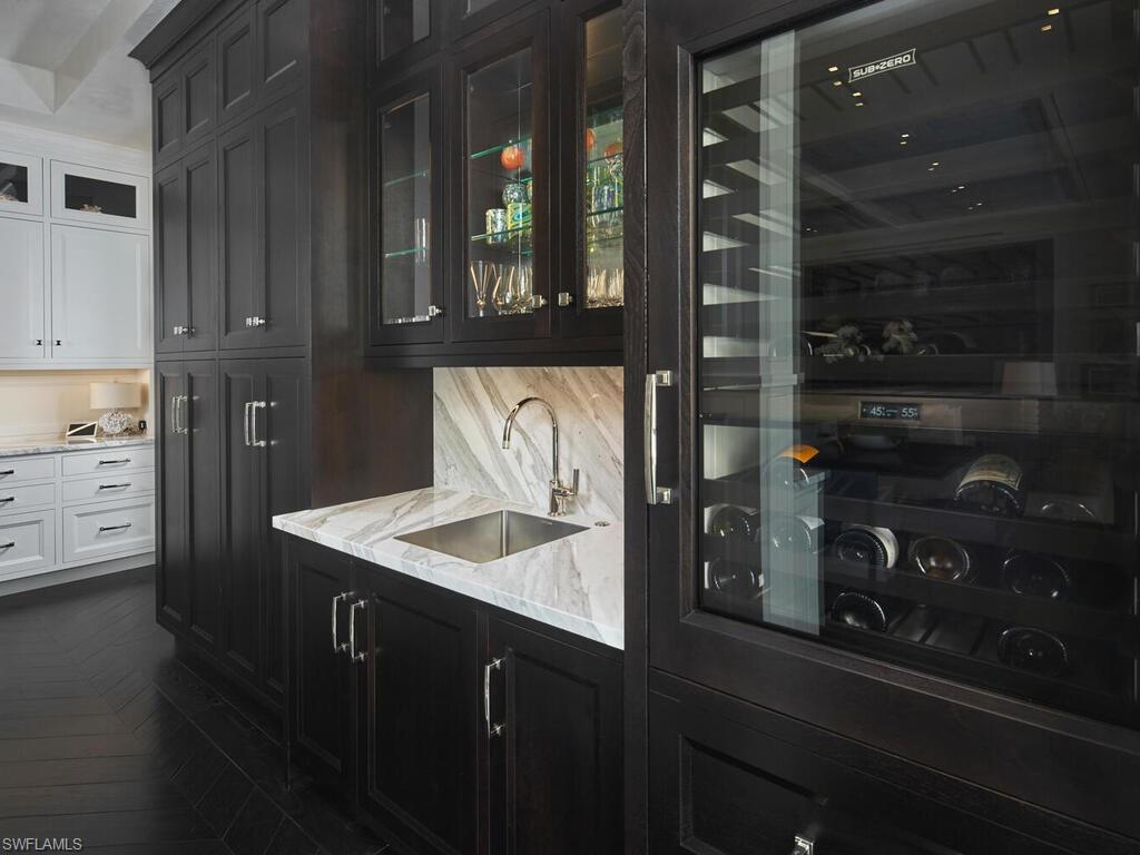 167 4th Street North Naples, FL 34102 - Photo 9 of 33 a kitchen with a sink and cabinets
