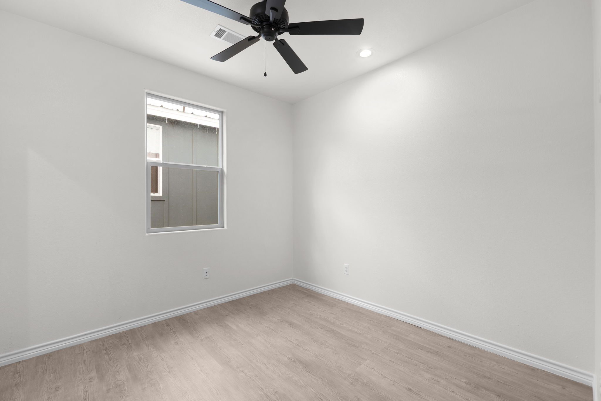 870 Waco Street Kingsland, TX 78639 - Photo 10 of 30 an empty room with a window and a fan