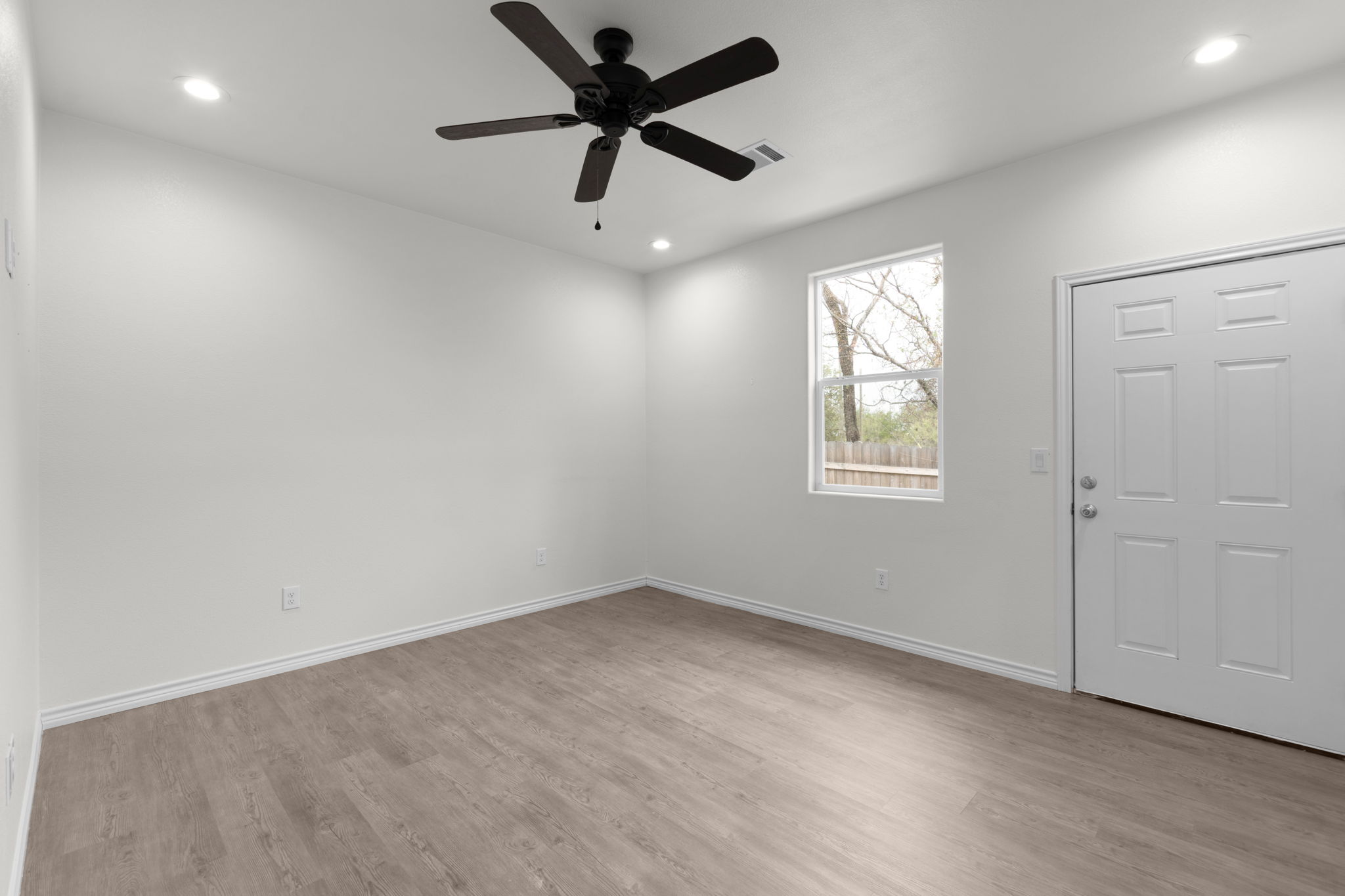 870 Waco Street Kingsland, TX 78639 - Photo 11 of 30 an empty room with a window and a fan