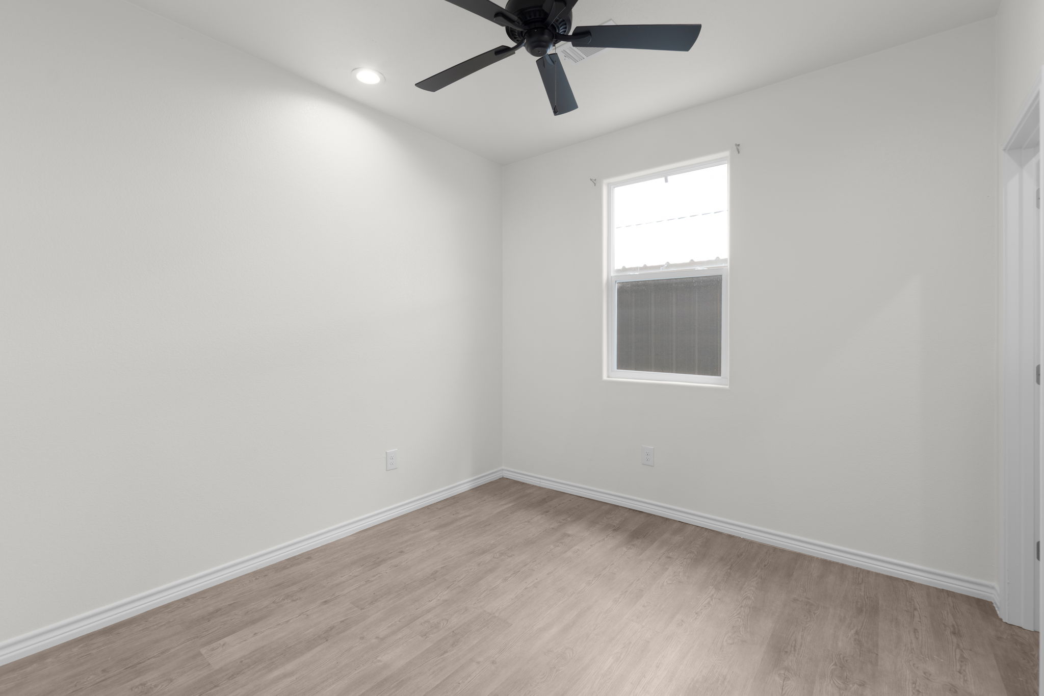 870 Waco Street Kingsland, TX 78639 - Photo 21 of 30 an empty room with a window and a fan