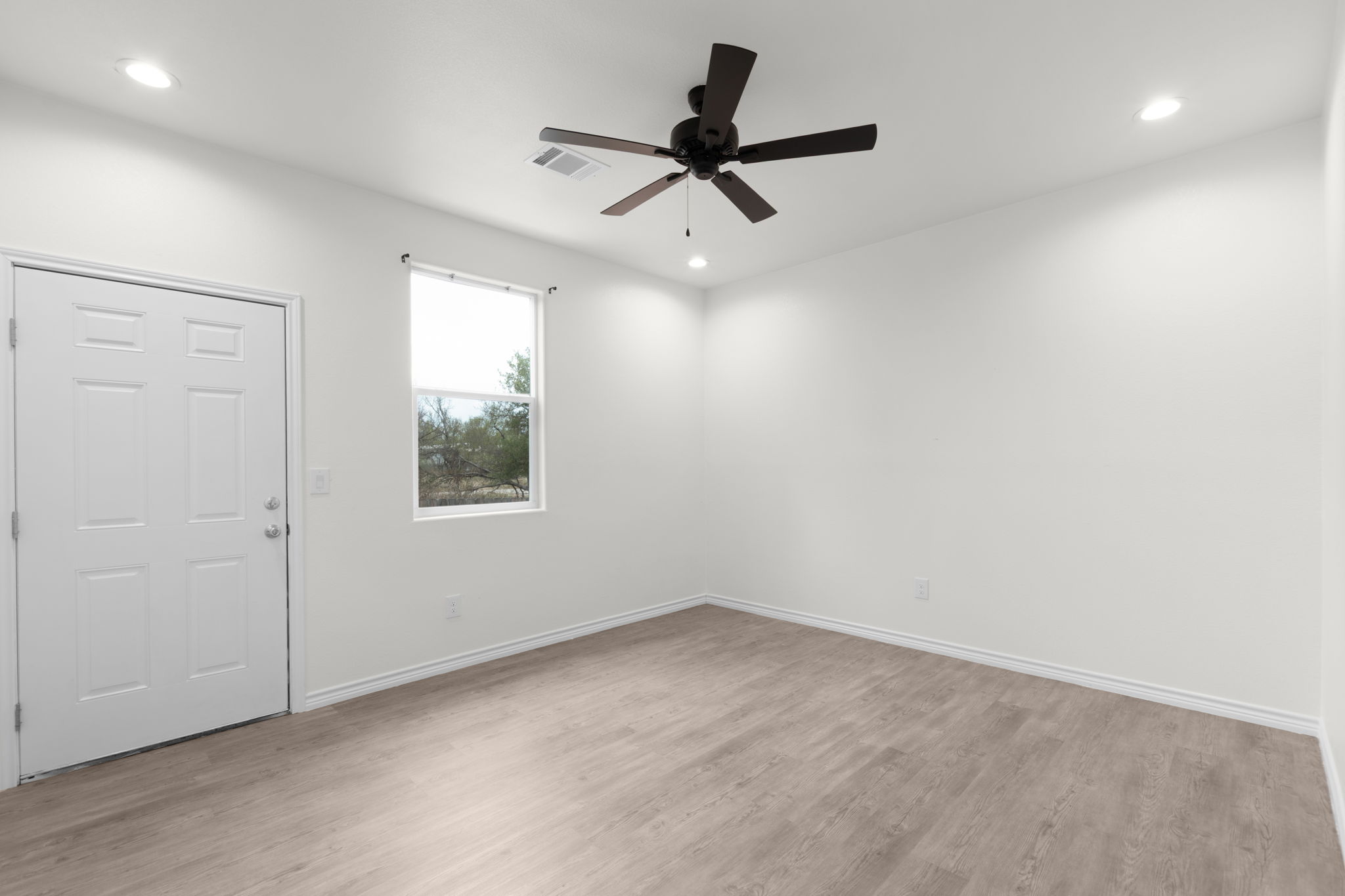 870 Waco Street Kingsland, TX 78639 - Photo 22 of 30 wooden floor in an empty room with a window