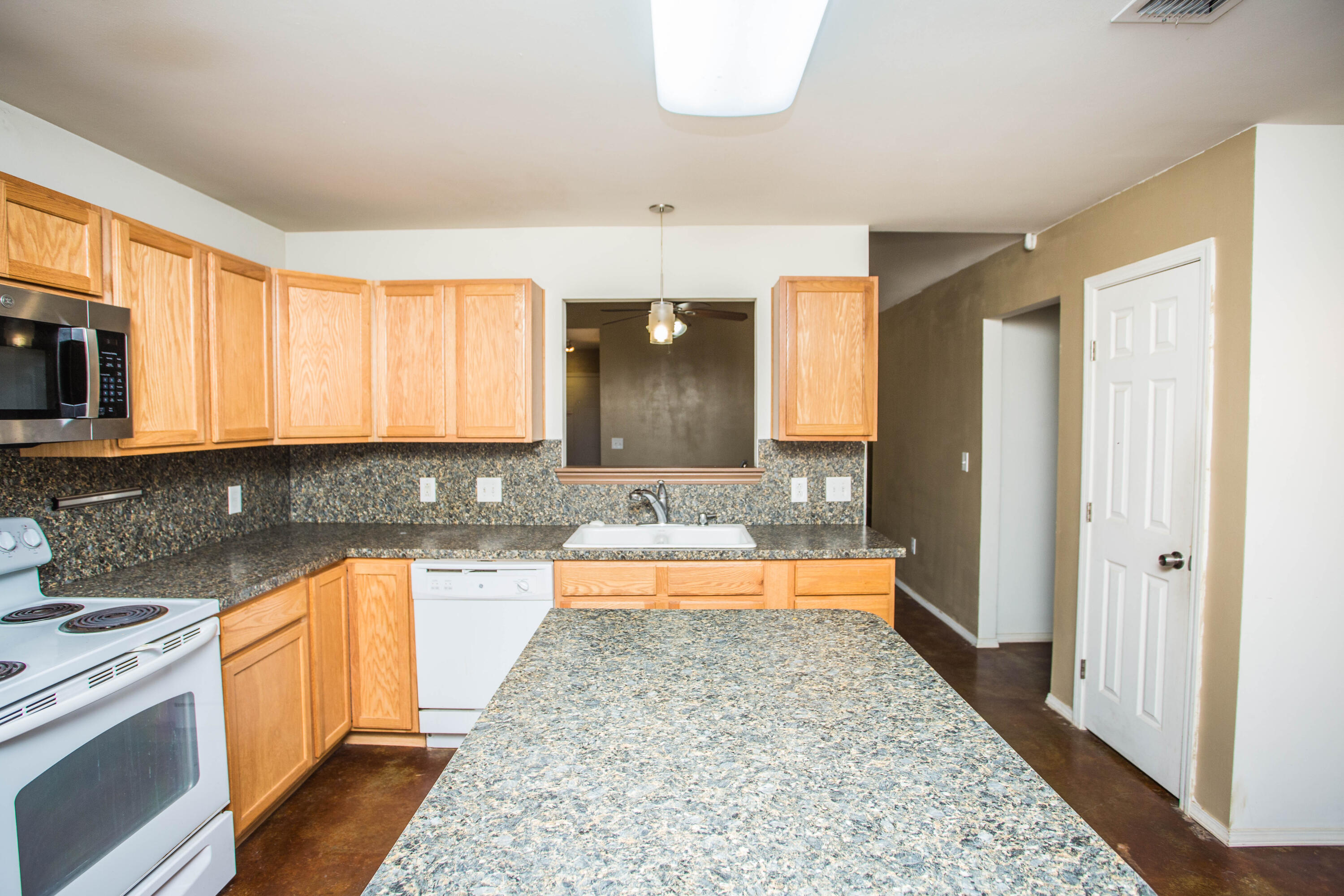 6114 22nd Street, Unit 2 Lubbock, TX 79407 - Photo 11 of 48 a large kitchen with a window and stainless steel appliances