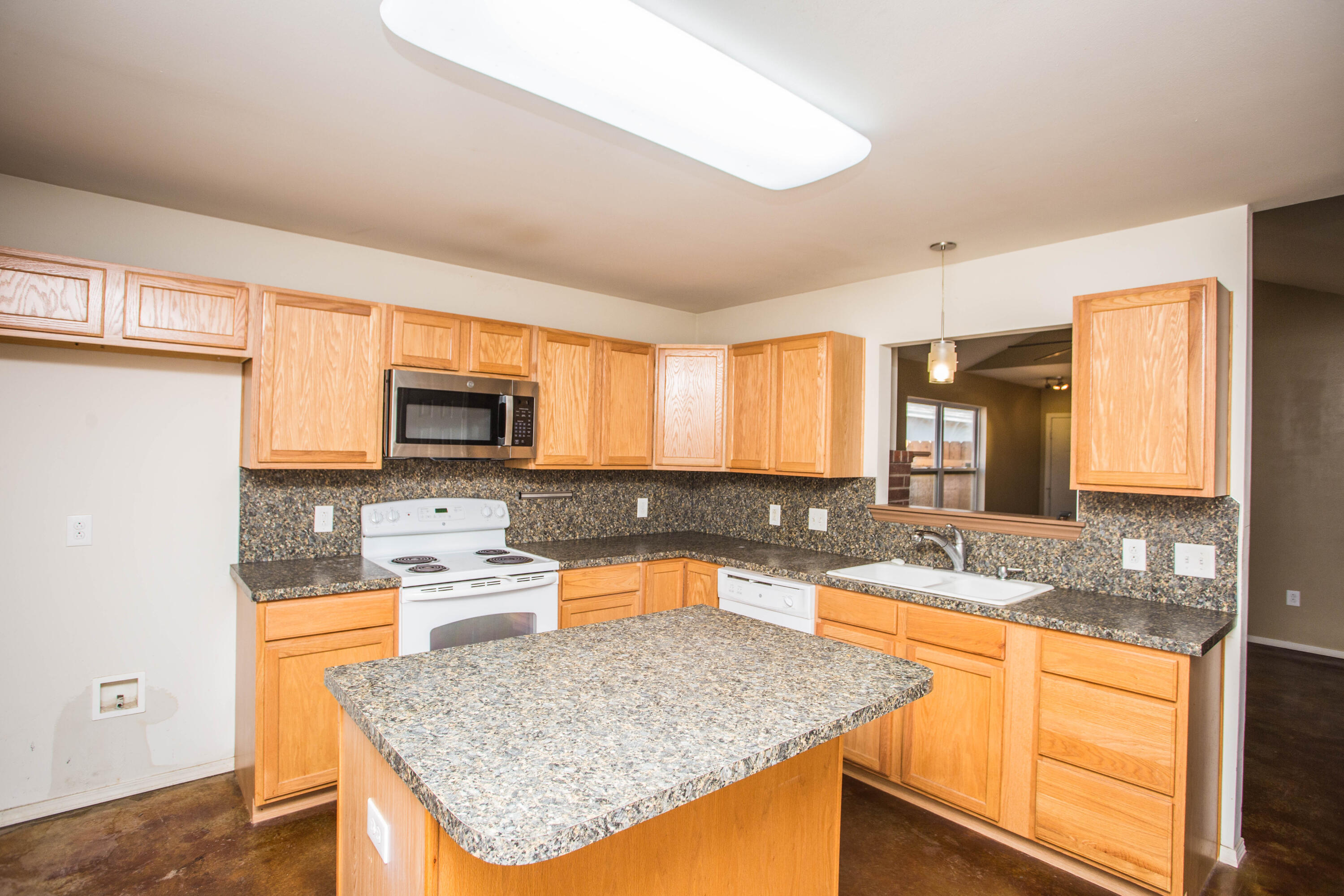 6114 22nd Street, Unit 2 Lubbock, TX 79407 - Photo 13 of 48 a kitchen with stainless steel appliances granite countertop a sink stove and refrigerator