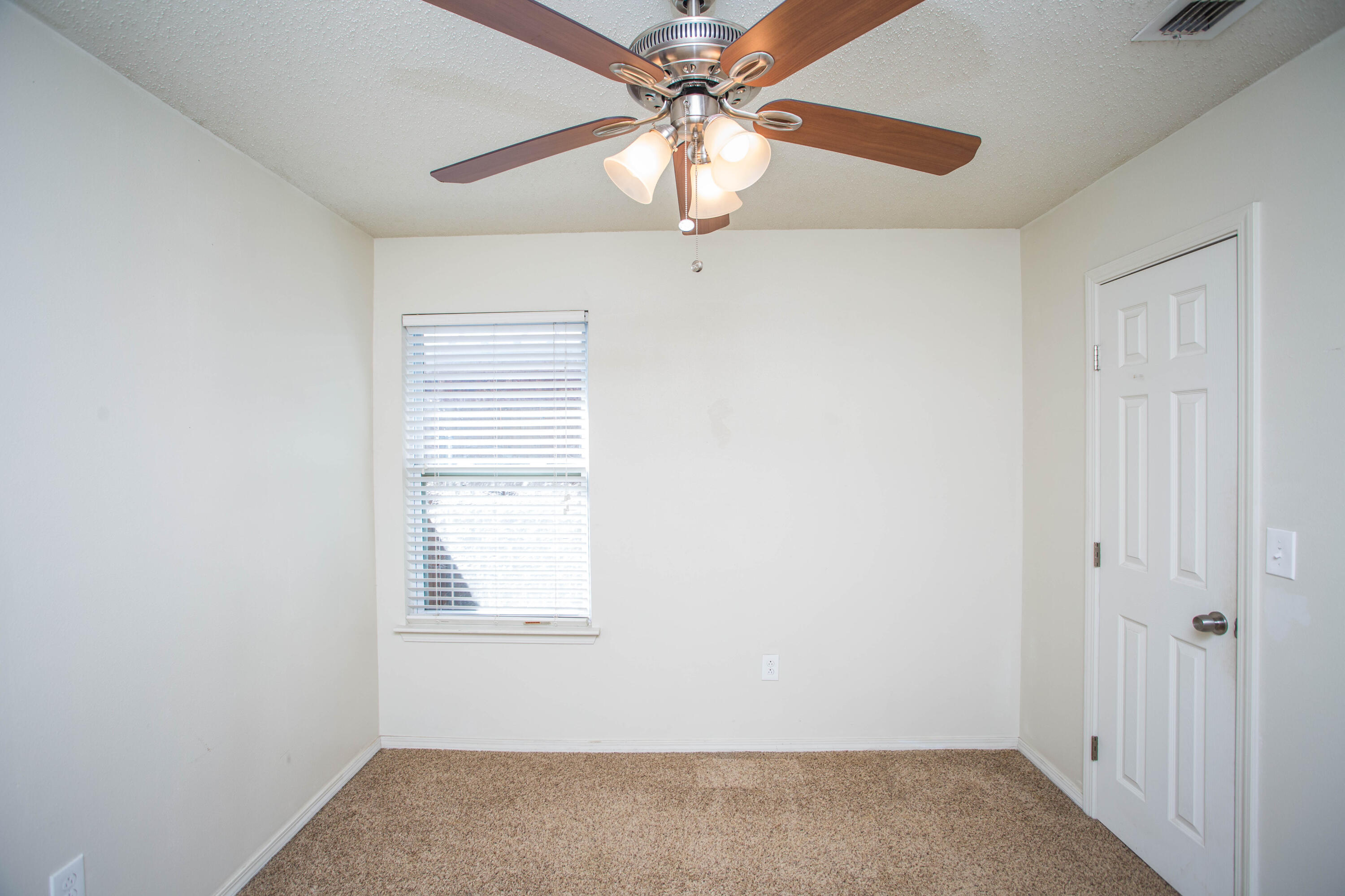 6114 22nd Street, Unit 2 Lubbock, TX 79407 - Photo 18 of 48 an empty room with windows and fan