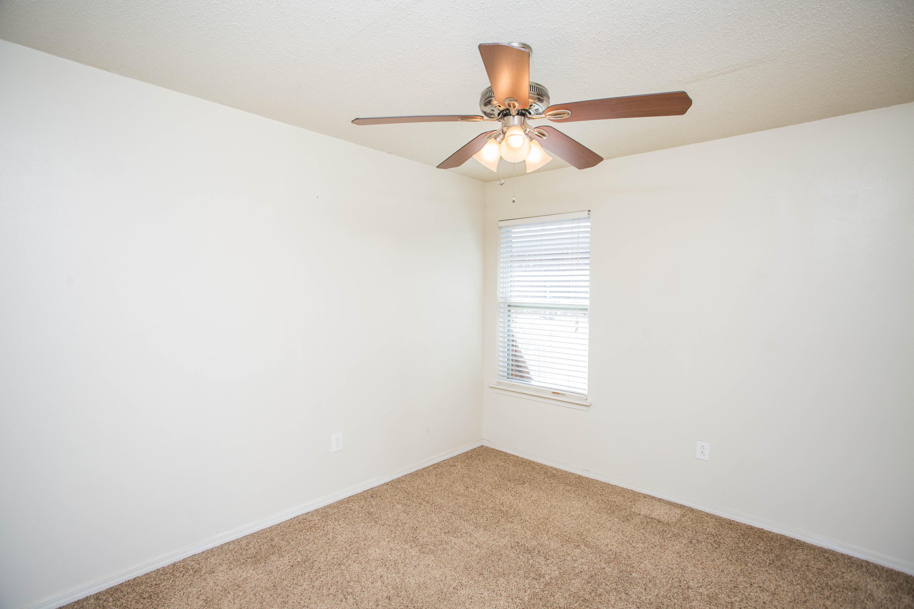 6114 22nd Street, Unit 2 Lubbock, TX 79407 - Photo 20 of 48 an empty room with a window and a fan