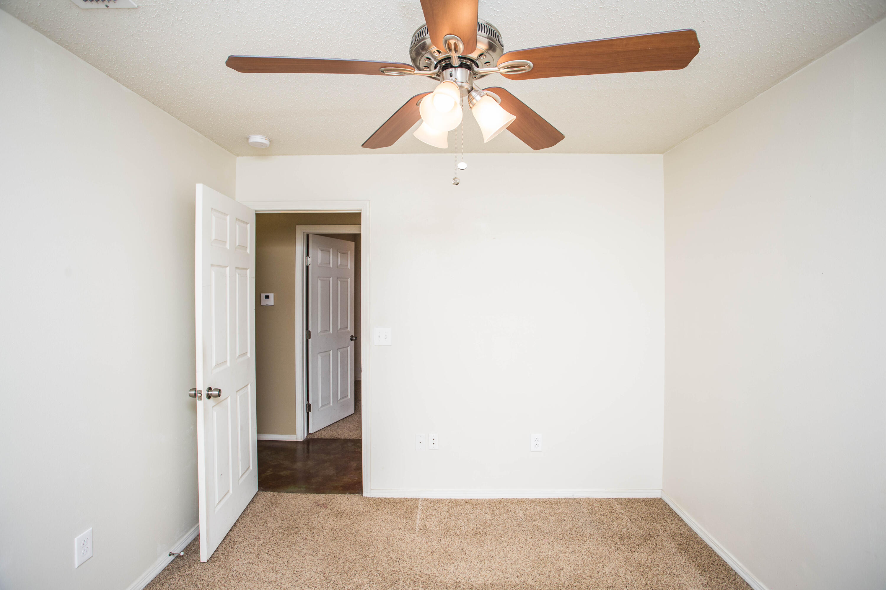 6114 22nd Street, Unit 2 Lubbock, TX 79407 - Photo 21 of 48 a view of a hallway with a ceiling fan and a chandelier fan