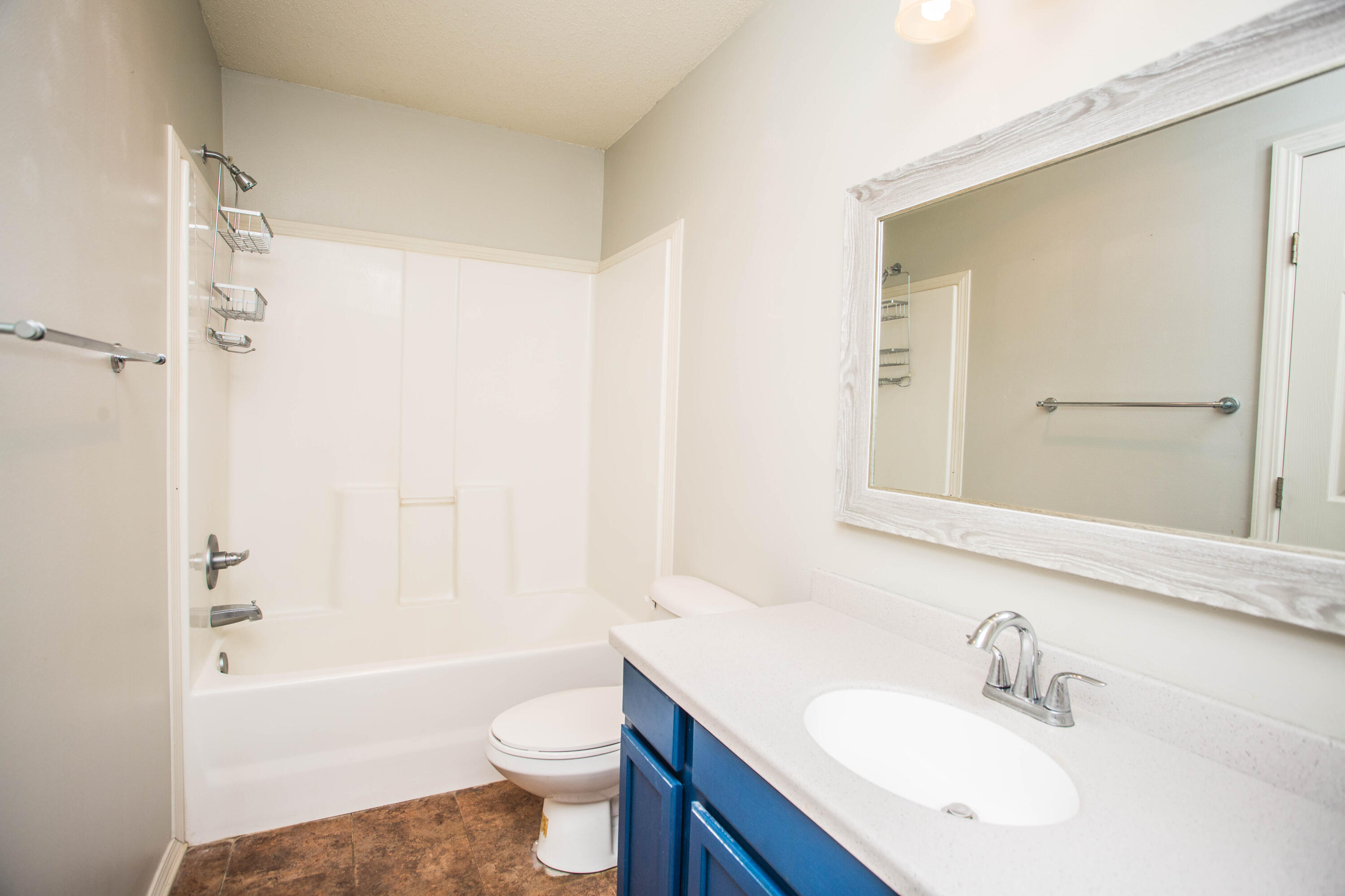 6114 22nd Street, Unit 2 Lubbock, TX 79407 - Photo 28 of 48 a bathroom with a sink a toilet and shower