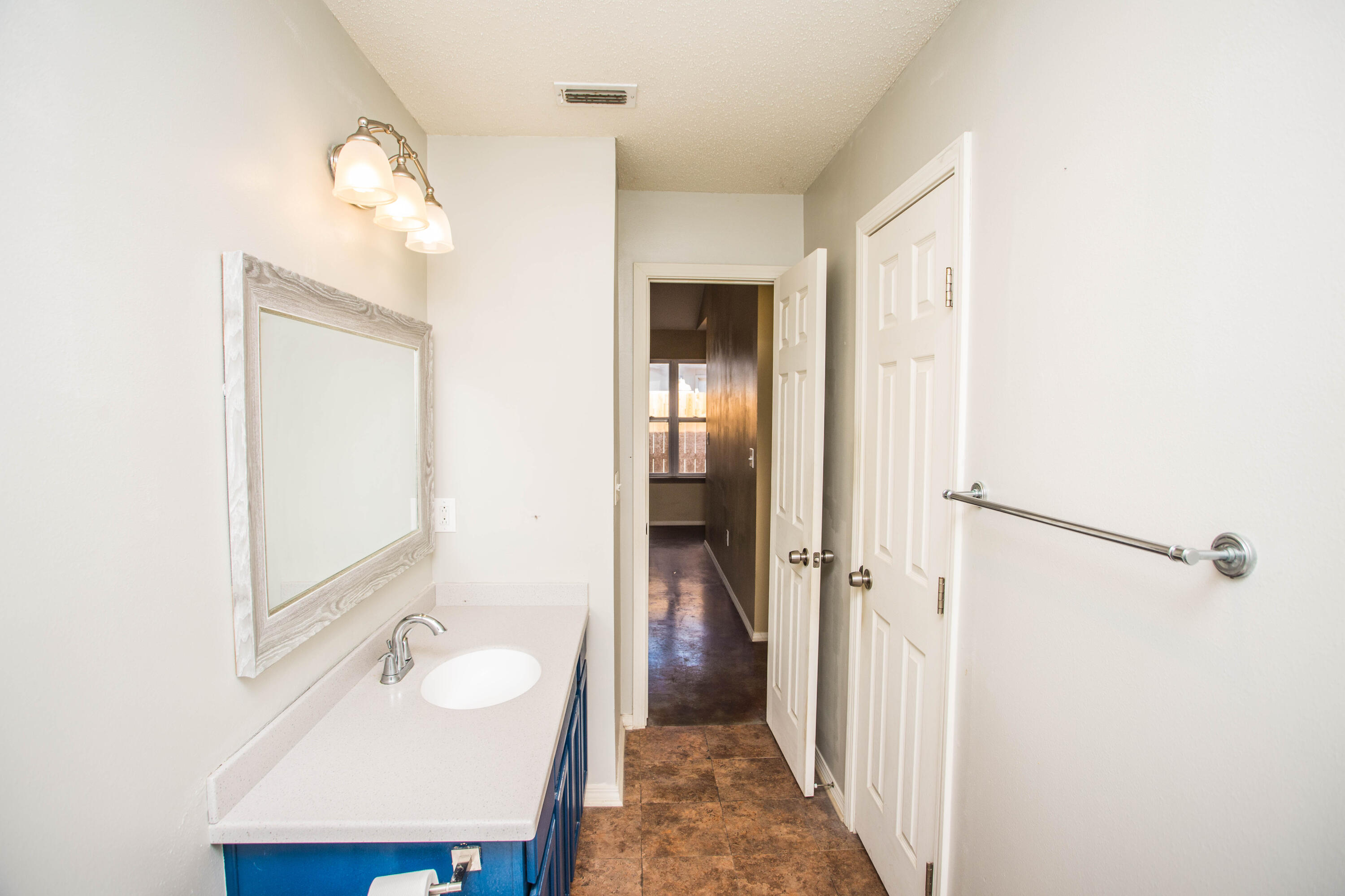 6114 22nd Street, Unit 2 Lubbock, TX 79407 - Photo 29 of 48 a bathroom with a sink and a mirror