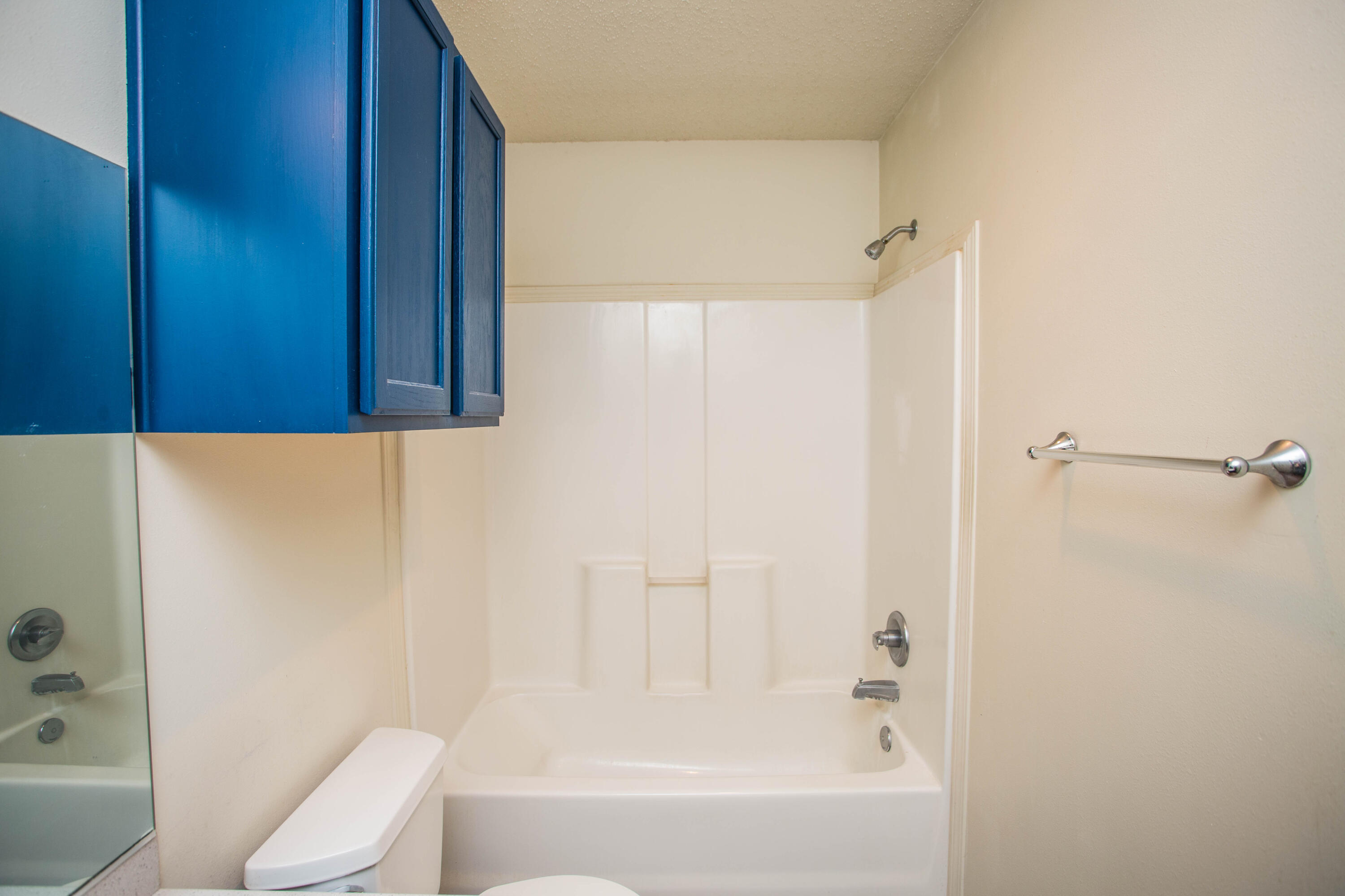 6114 22nd Street, Unit 2 Lubbock, TX 79407 - Photo 30 of 48 a bathroom with a bathtub and a shower
