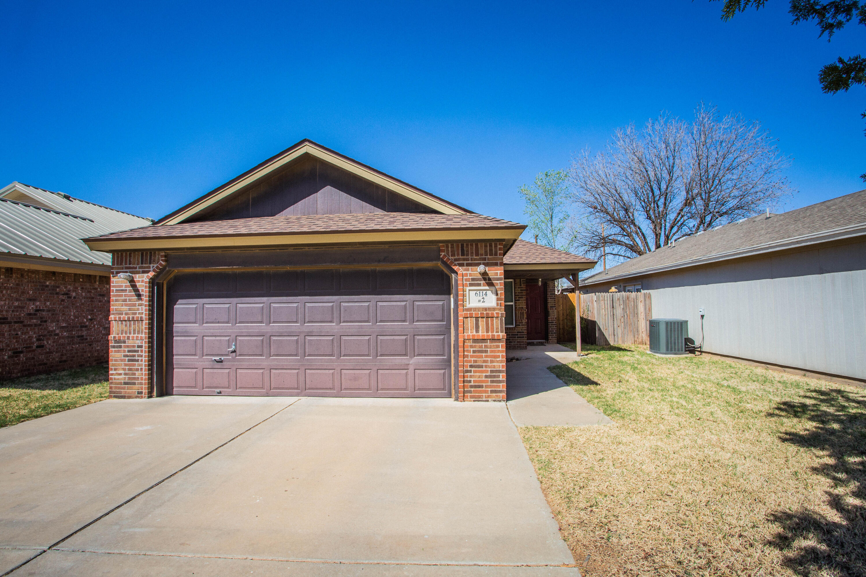 6114 22nd Street, Unit 2 Lubbock, TX 79407 - Photo 3 of 48 a front view of a house with a yard