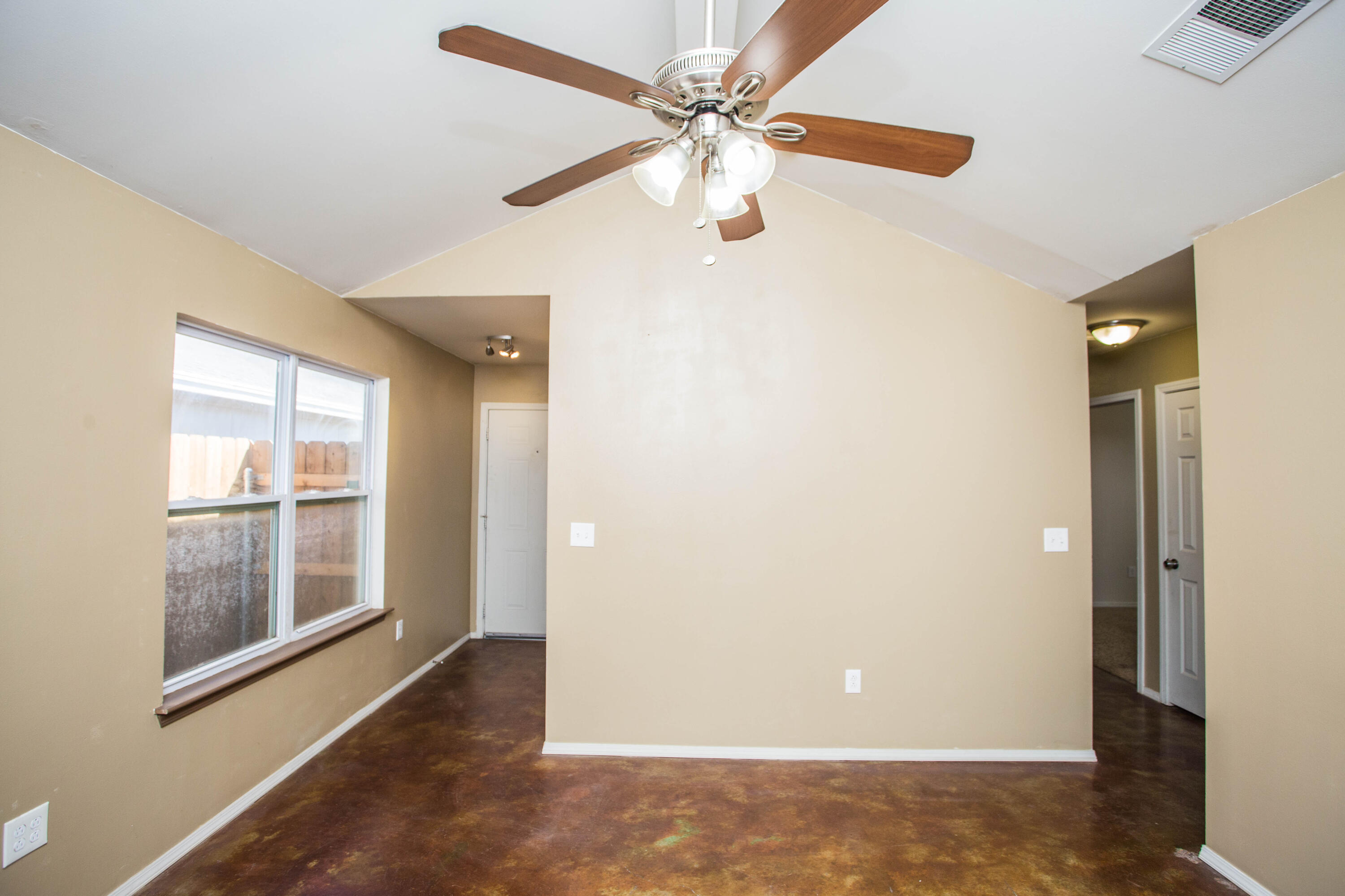 6114 22nd Street, Unit 2 Lubbock, TX 79407 - Photo 7 of 48 a view of an empty room with a window