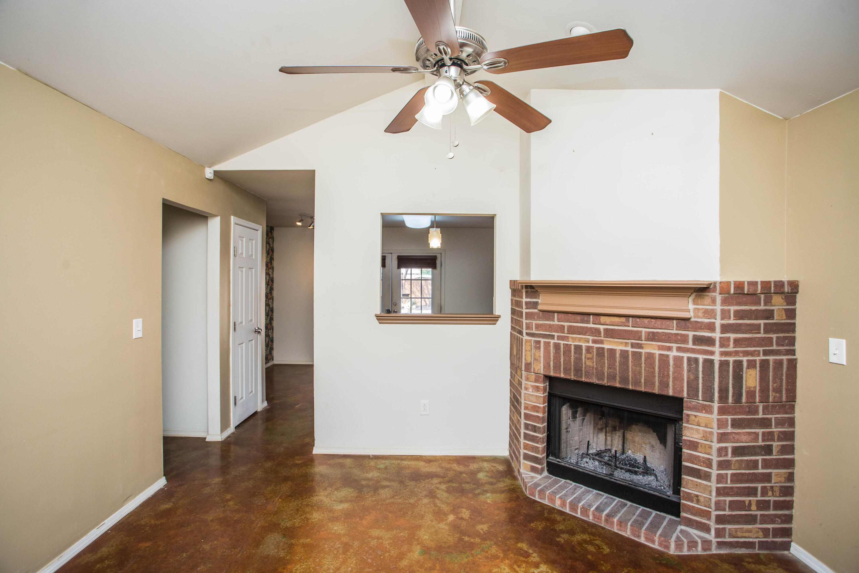 6114 22nd Street, Unit 2 Lubbock, TX 79407 - Photo 9 of 48 a view of an empty room with a fireplace