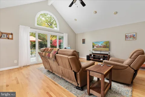a living room with furniture a window and a flat screen tv