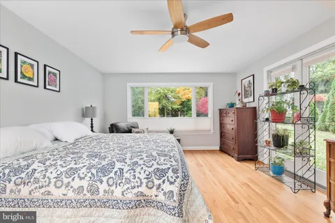 a bedroom with a bed dresser and a window