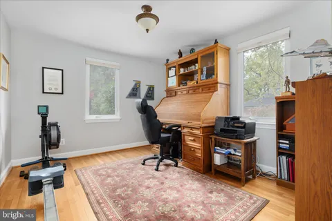 a view of a workspace with furniture and a window