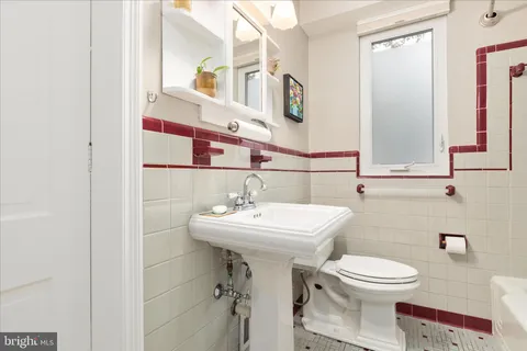 a bathroom with a sink toilet and mirror