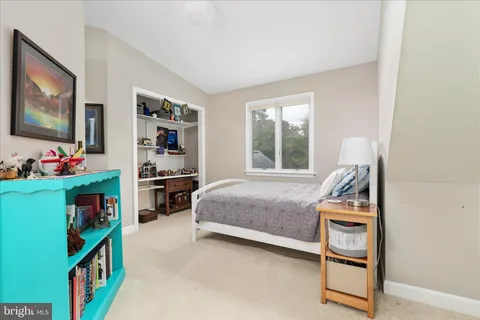 a bedroom with furniture and a flat screen tv