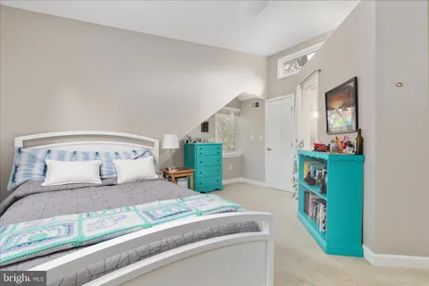 a bedroom with a bed and a mirror