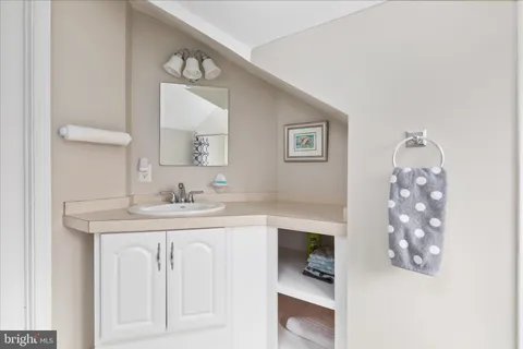 a bathroom with a sink vanity and a mirror