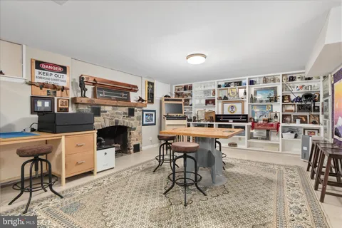 a work room with furniture a flat screen tv and a rug
