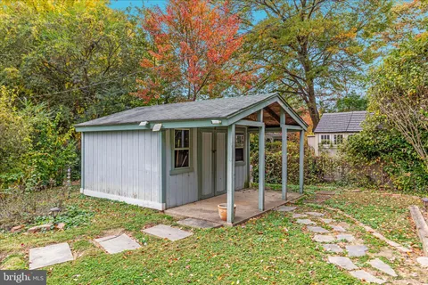a view of a backyard with a garden and entertaining space