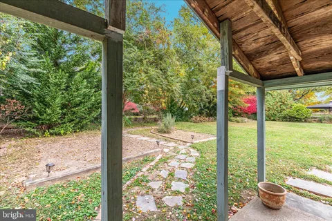 a front view of a house with swimming pool and sitting area