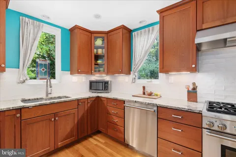 a kitchen with a sink stove and window