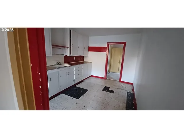 a kitchen with stainless steel appliances kitchen island granite countertop a refrigerator