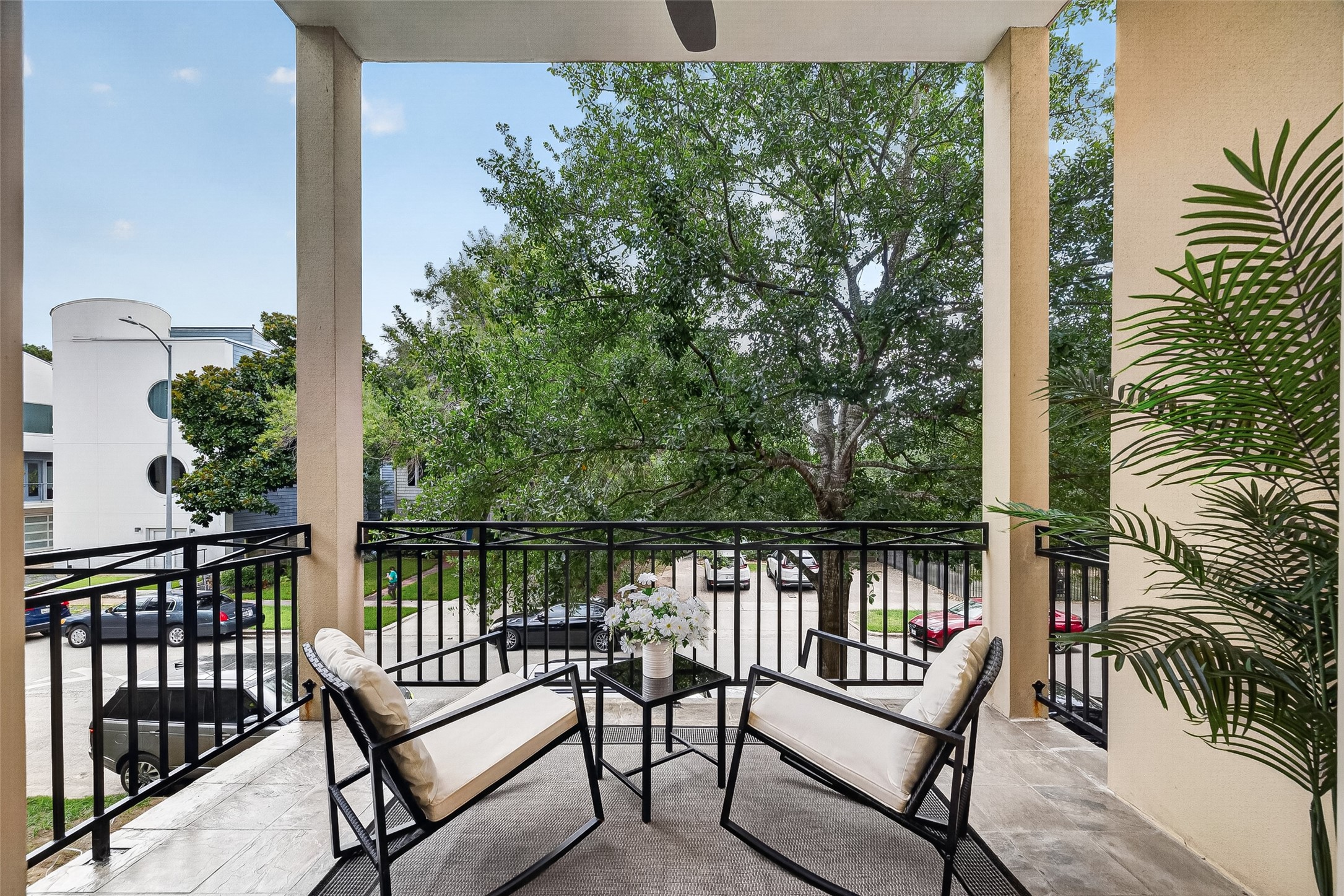 2034 Colquitt Street, Unit A Houston, TX 77098 - Photo 19 of 41 This inviting 2nd floor balcony offers a serene outdoor space with comfortable seating and lush greenery, perfect for relaxation and enjoying the view.