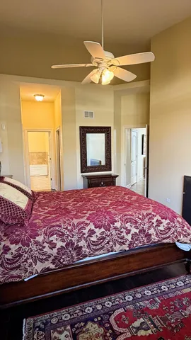 a bedroom with a bed and a chandelier