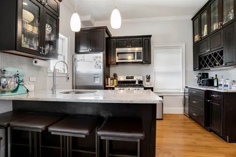 a kitchen with a sink cabinets and window