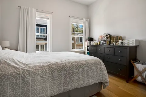 a bedroom with a bed and window