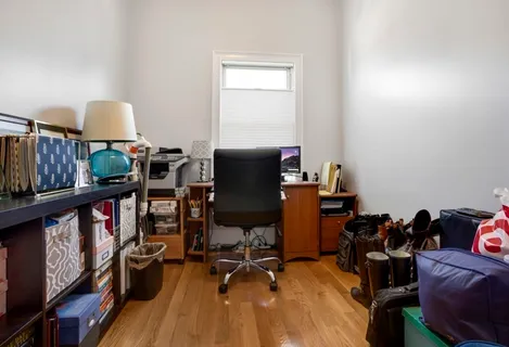 a view of a workspace with furniture and wooden floor