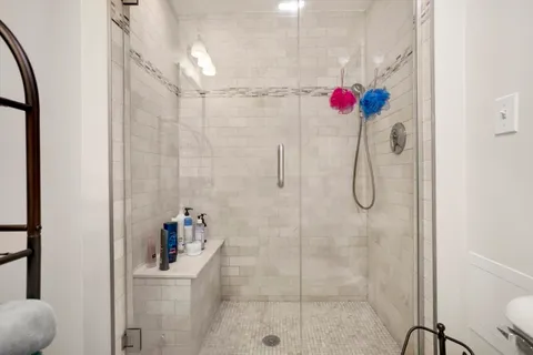 a bathroom with a shower and a shower
