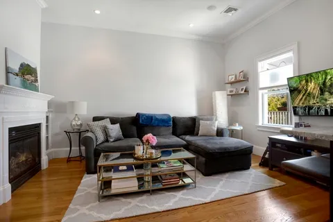 a living room with furniture fireplace and flat screen tv