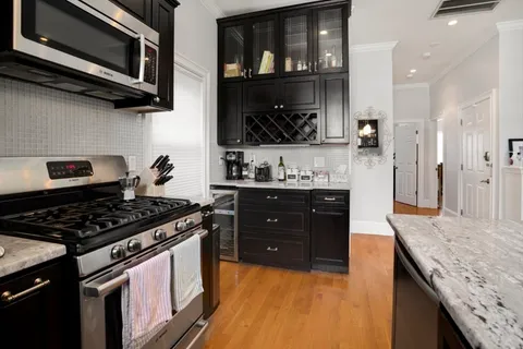 a kitchen with stainless steel appliances granite countertop a stove and a microwave